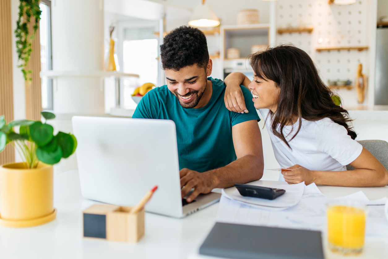 a couple working together on a laptop