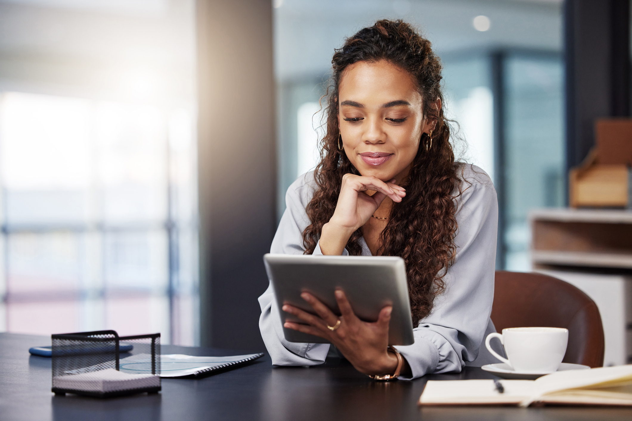 a happy woman with a tablet